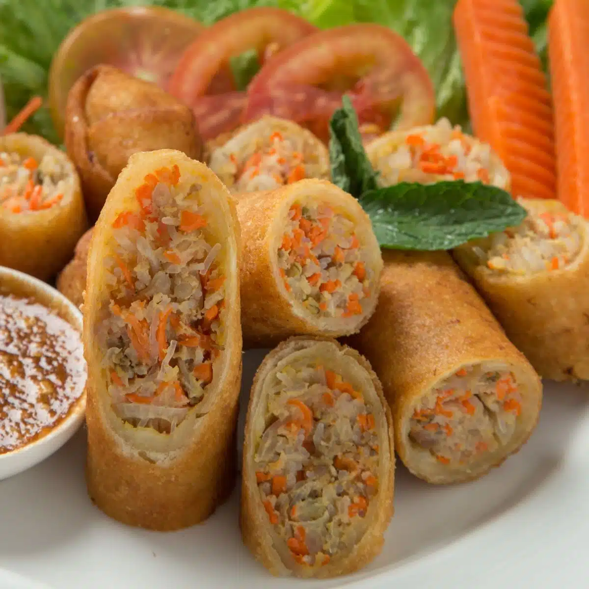 Square image showing Thai spring rolls on a plate.