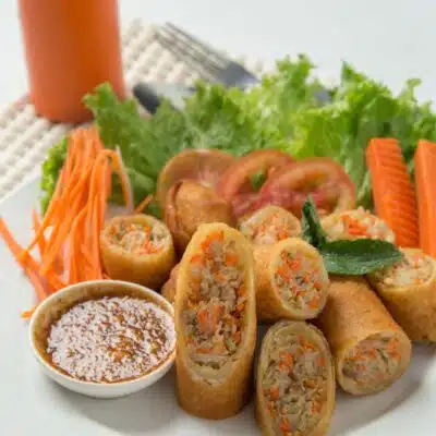 Tall image showing Thai spring rolls on a plate.