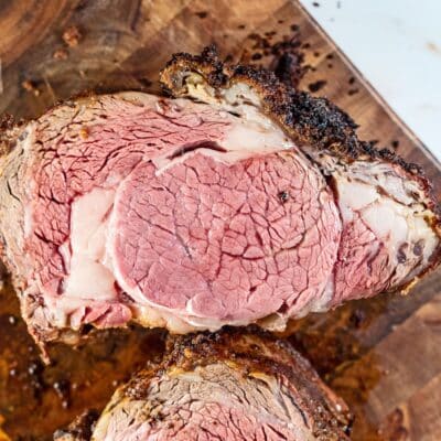 How to freeze leftover prime rib after cooking your holiday roast or special occasion meal so it's juicy and wonderful later like this satisfying sliced portion on a wooden cutting board.