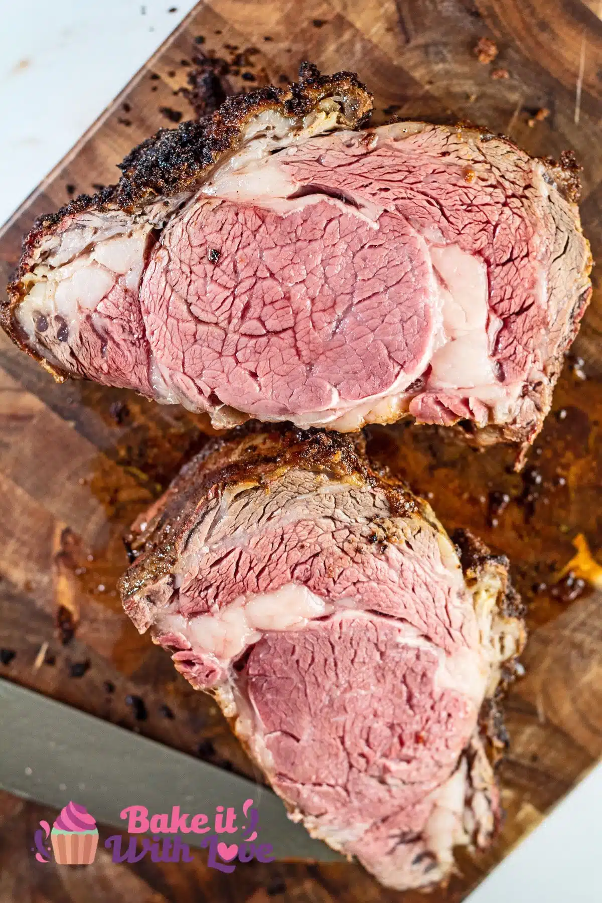 No peek closed door prime rib sliced in half and showing how perfectly medium rare the roast beef is.