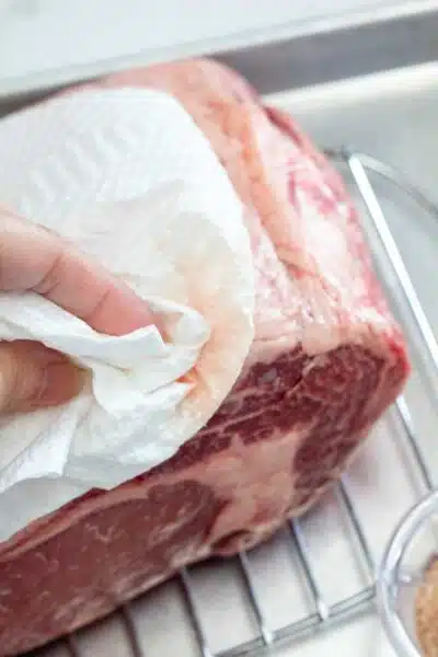 Process image 1 showing patting dry the prime rib roast.
