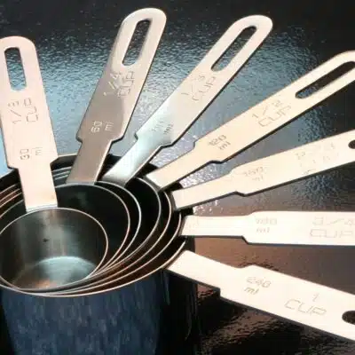 Square image for converting cups to teaspoons, showing measuring cups.