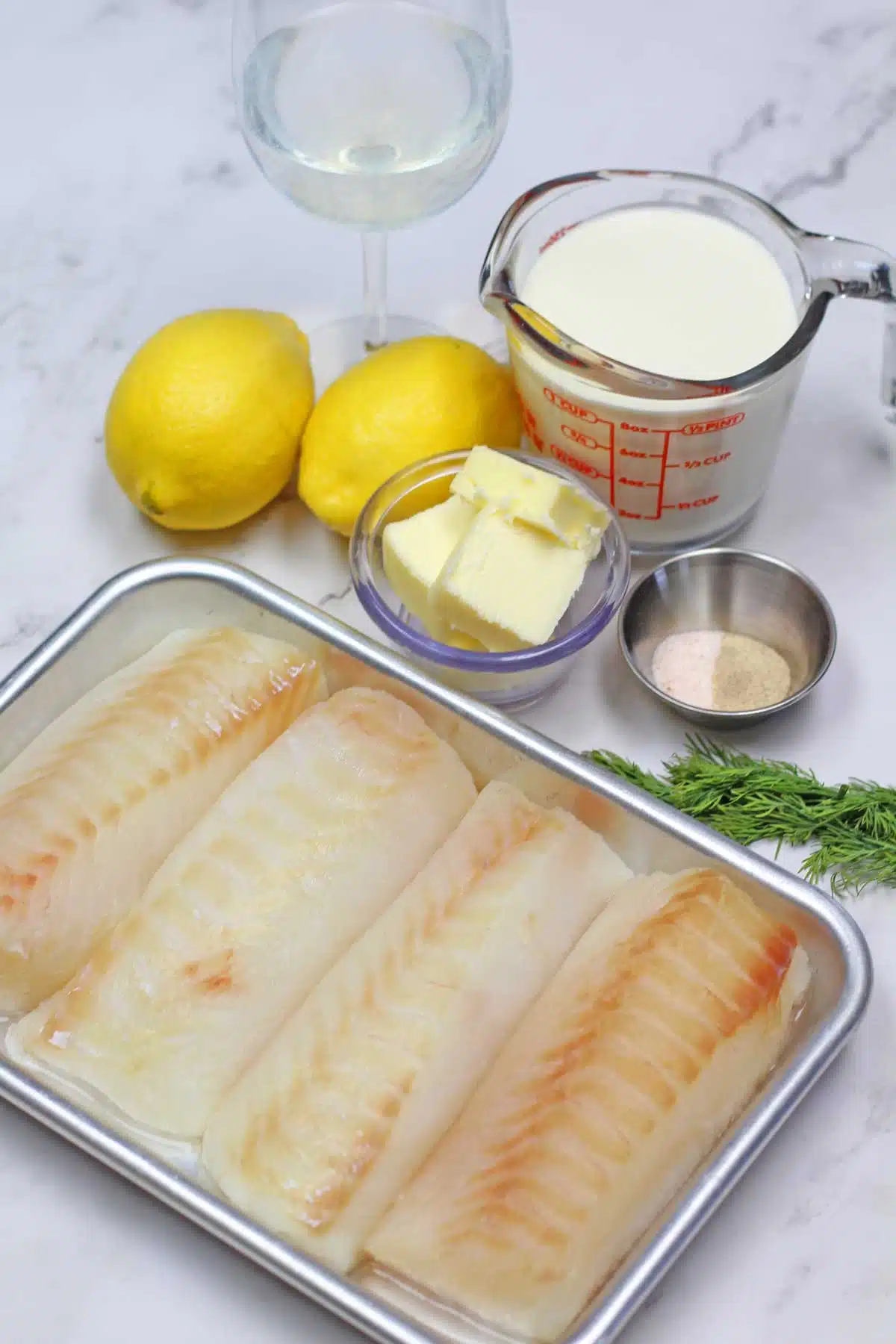 Ingredient image showing what is needed to make lemon butter baked cod.