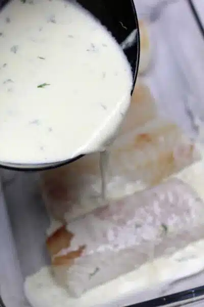 Process image 3 showing pouring cream mixture over cod fillets.