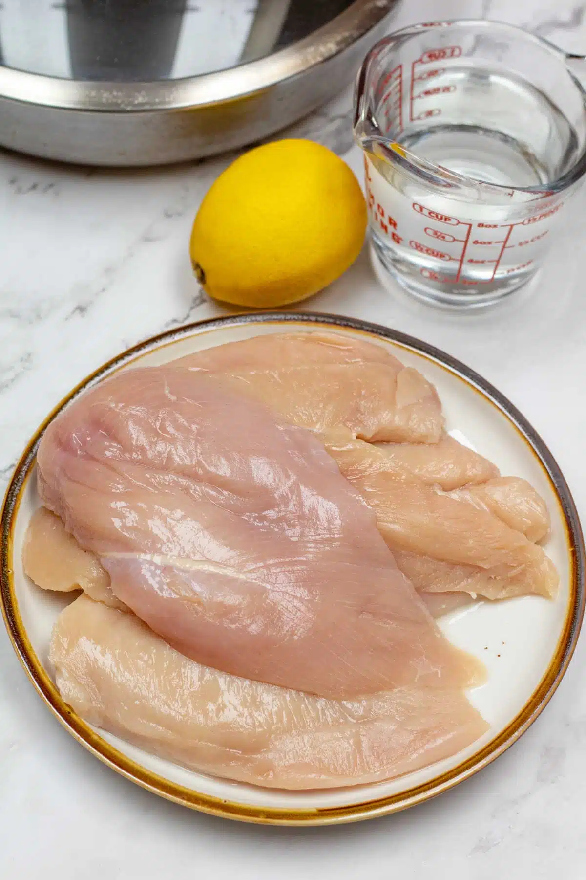 Easy poached chicken breasts cooking method needs only a few ingredients.