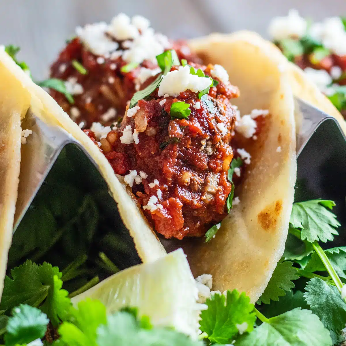 Best albondigas tacos recipe using hearty Mexican meatballs in a savory tomato and chipotle chili sauce.