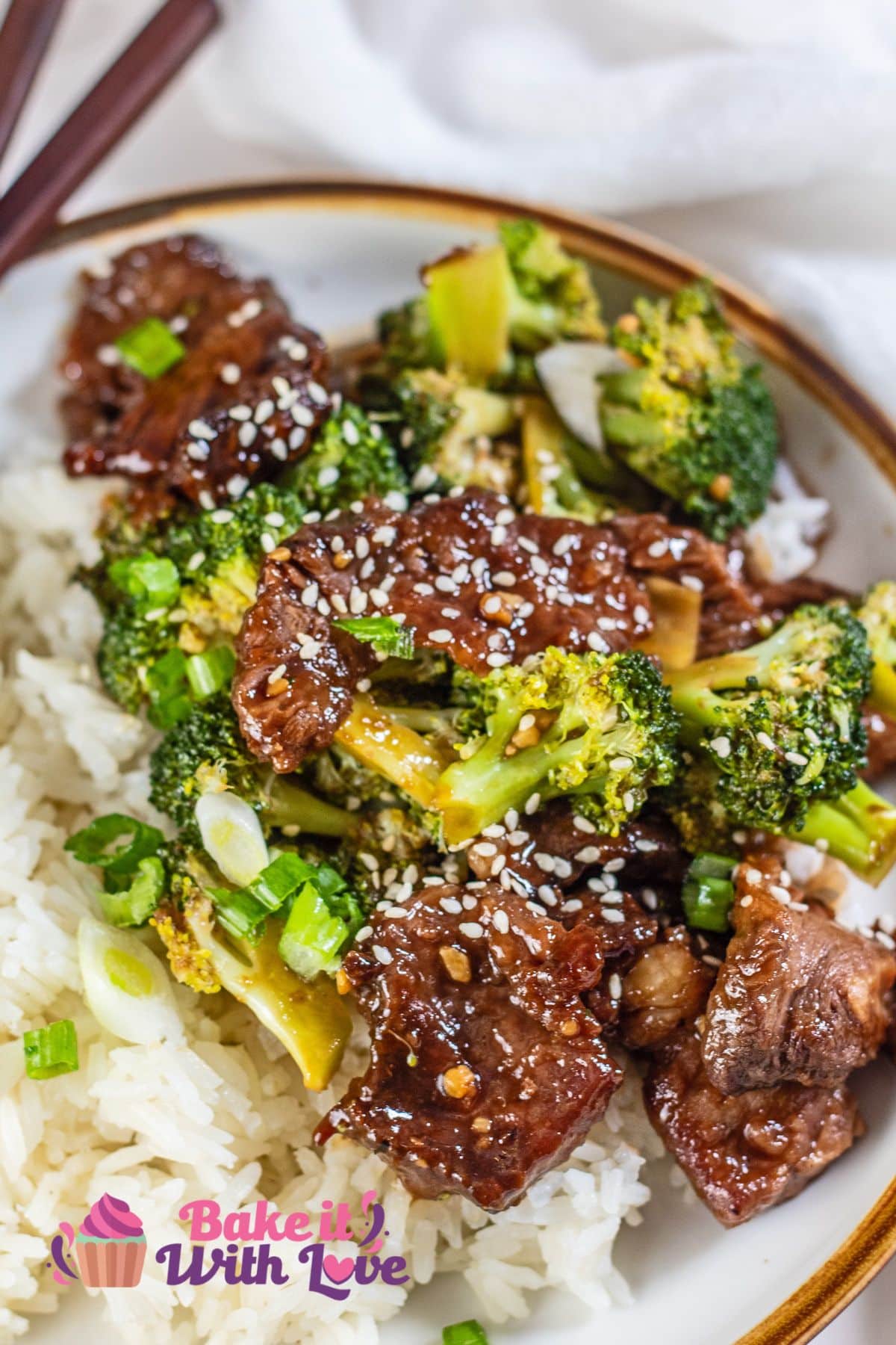 Tender wok fried beef and broccoli with leftover prime rib plated and garnished.