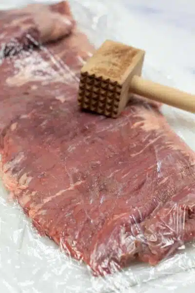 Process image 1 showing tenderizing the skirt steak.