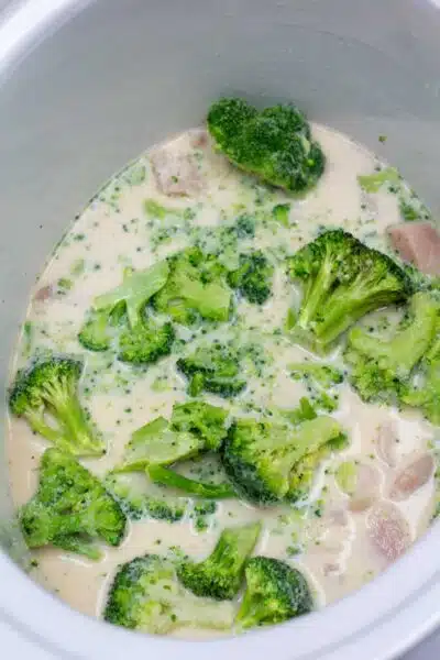 Crockpot cheesy chicken broccoli rice casserole process photo 5 add frozen broccoli florets then cover and cook.