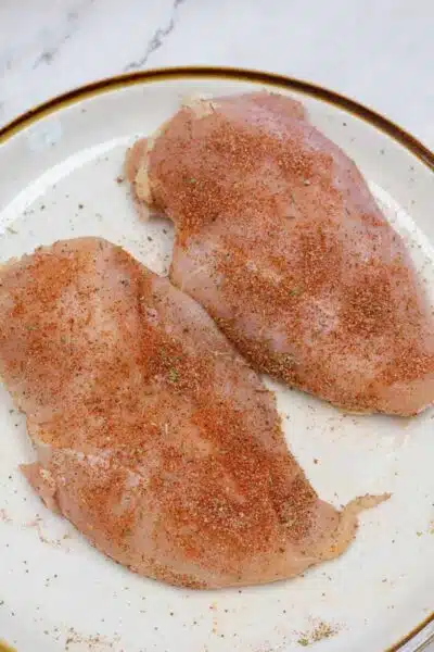 Process image 1 showing seasoned chicken breasts.