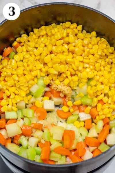 Turkey and dumplings soup process photo 3 adding the garlic and corn.