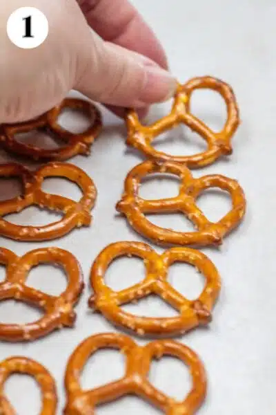 Valentine's Day pretzel hugs candies process photo 1 line up 48 mini pretzels on a parchment paper lined baking sheet.