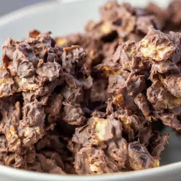 Wide image of chocolate raisin cornflakes candy clusters.