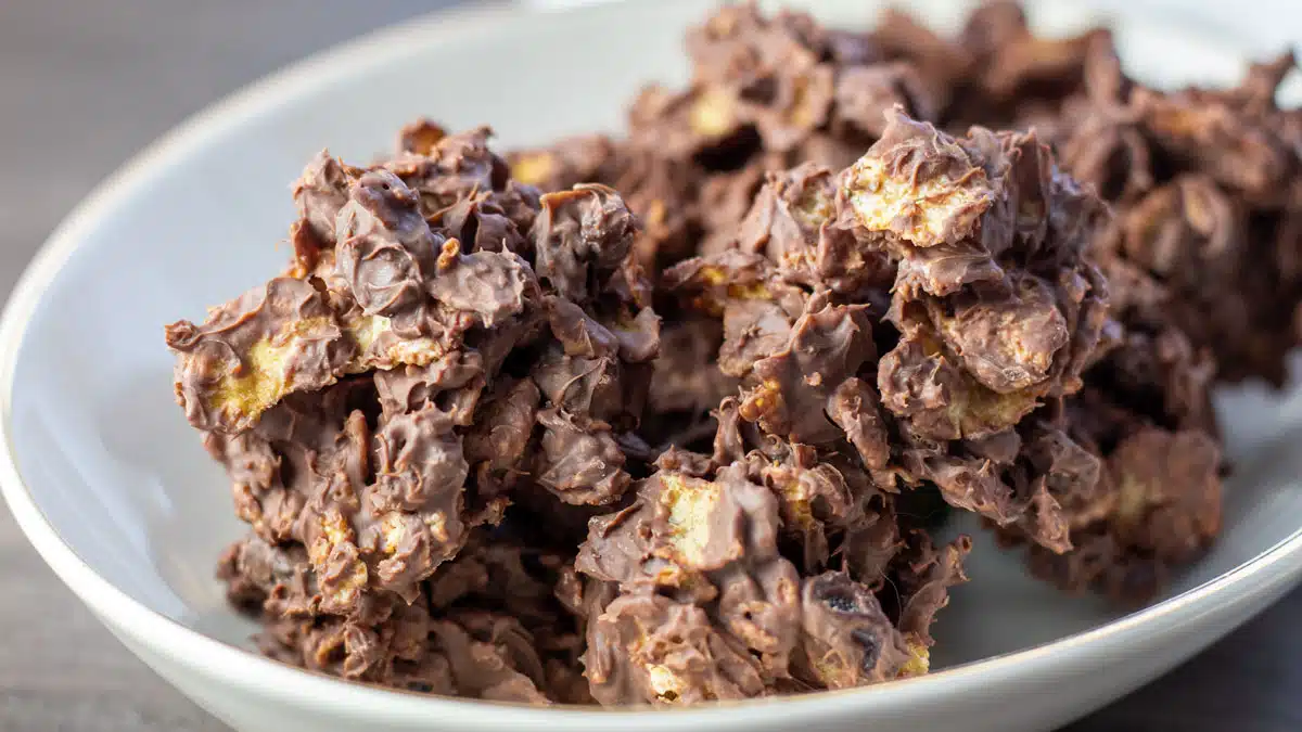 Wide image of chocolate raisin cornflakes candy clusters.