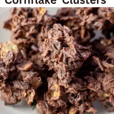Pin image with text overlay of chocolate raisin cornflakes candy clusters.