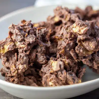 Square image of chocolate raisin cornflakes candy clusters.