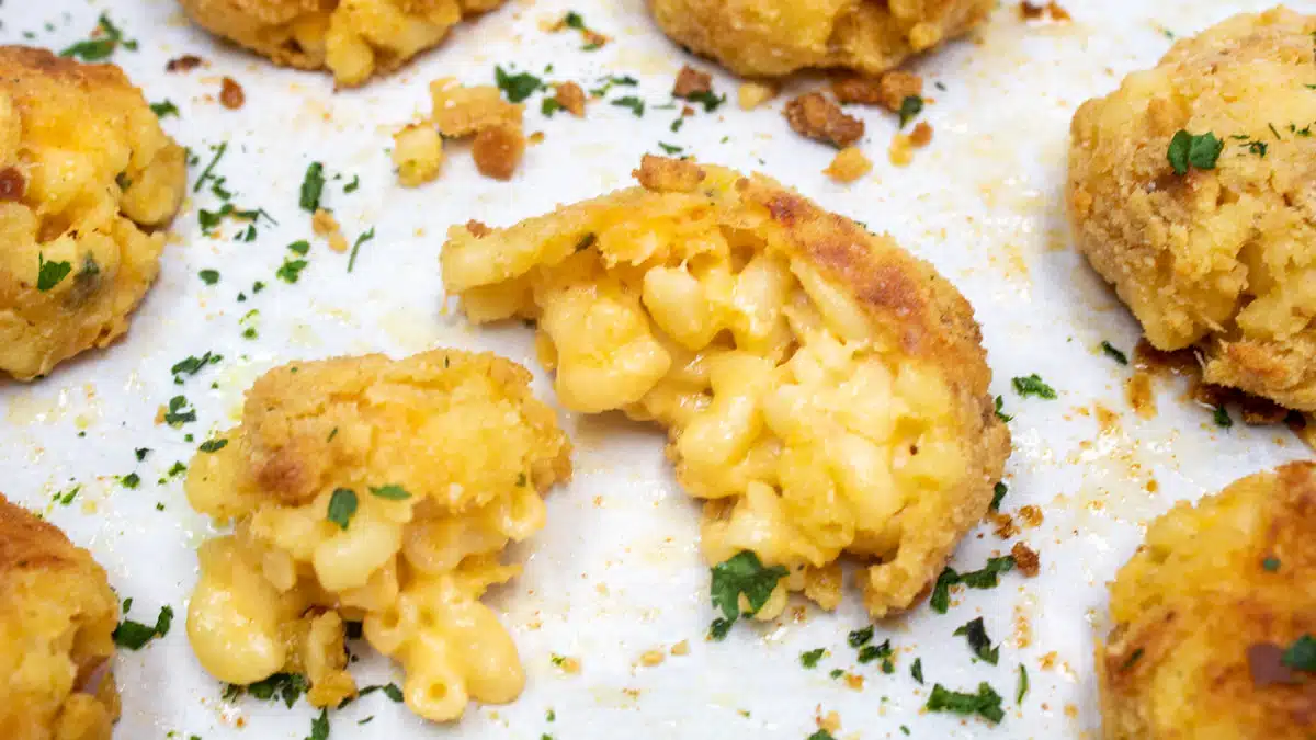 Wide image of breaded mac & cheese bites.