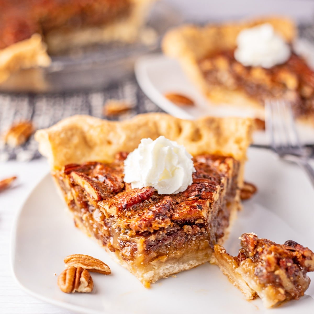 Best homemade Cracker Barrel chocolate pecan pie recipe baked and sliced, served on a white plate with a bite cut away.