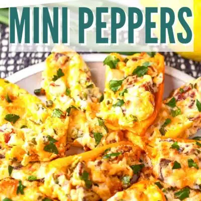 Bake It With Love pin for our cream cheese stuffed mini peppers with text header over plated peppers image.