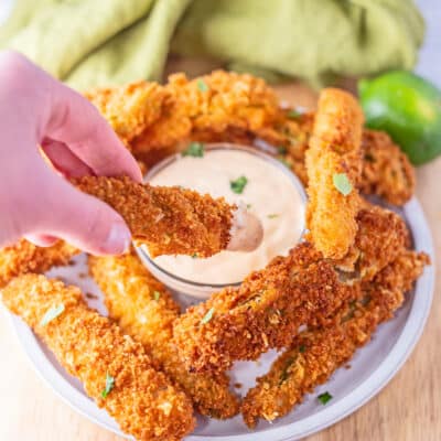 Best homemade Disney Parks Carnation Cafe fried pickle spears copycat recipe shown with the house dipping sauce.