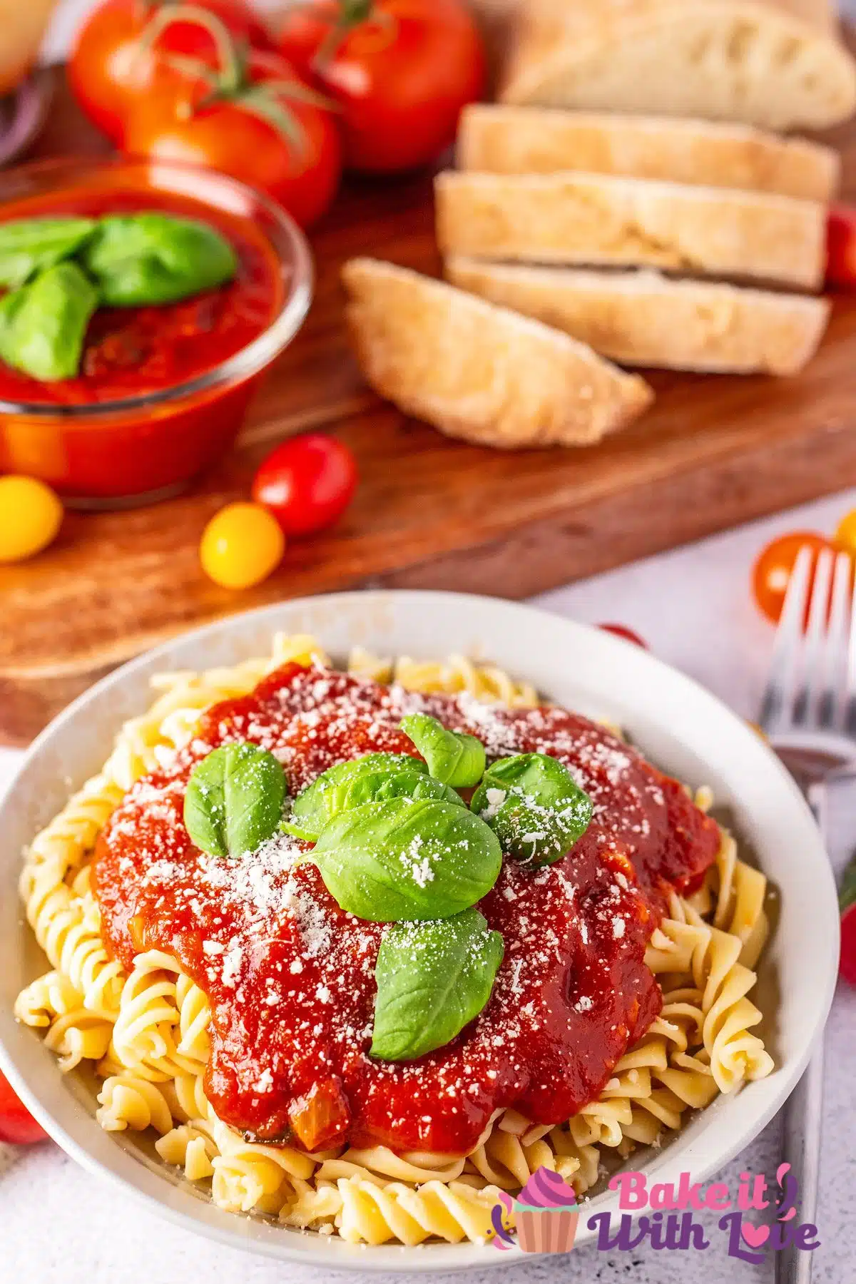 Tasty pomodoro sauce served over pasta and topped with fresh basil leaves and Parmesan cheese.