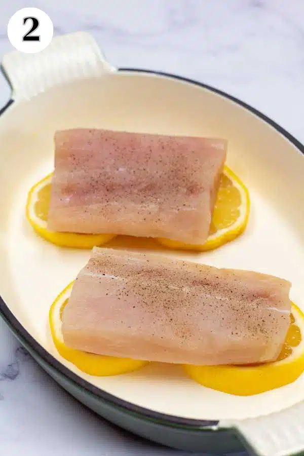 Process photo 2 showing mahi mahi fillets on lemon slices in baking dish.