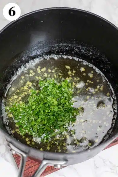 Process photo 6 showing added parsley and garlic in butter lemon sauce.