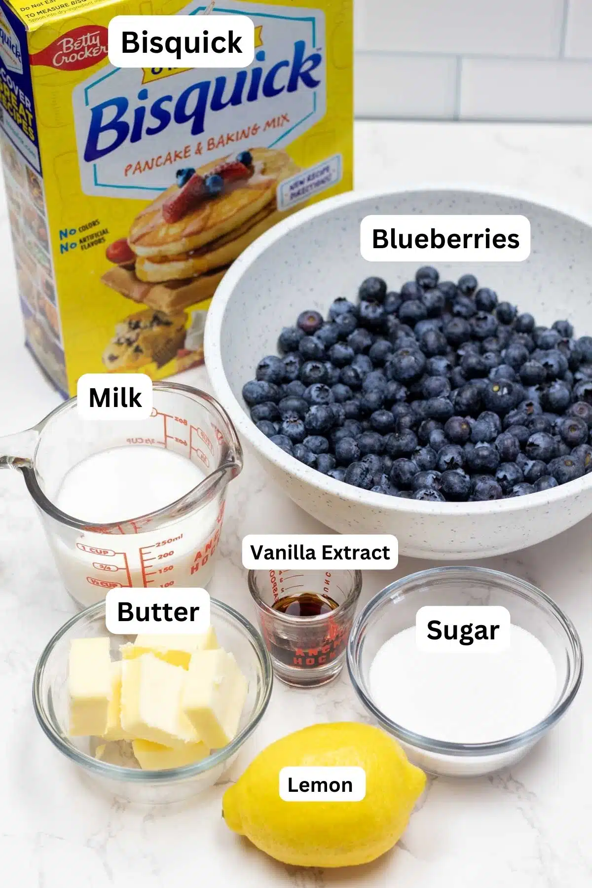Tall image of the ingredients for Bisquick blueberry cobbler with labels.