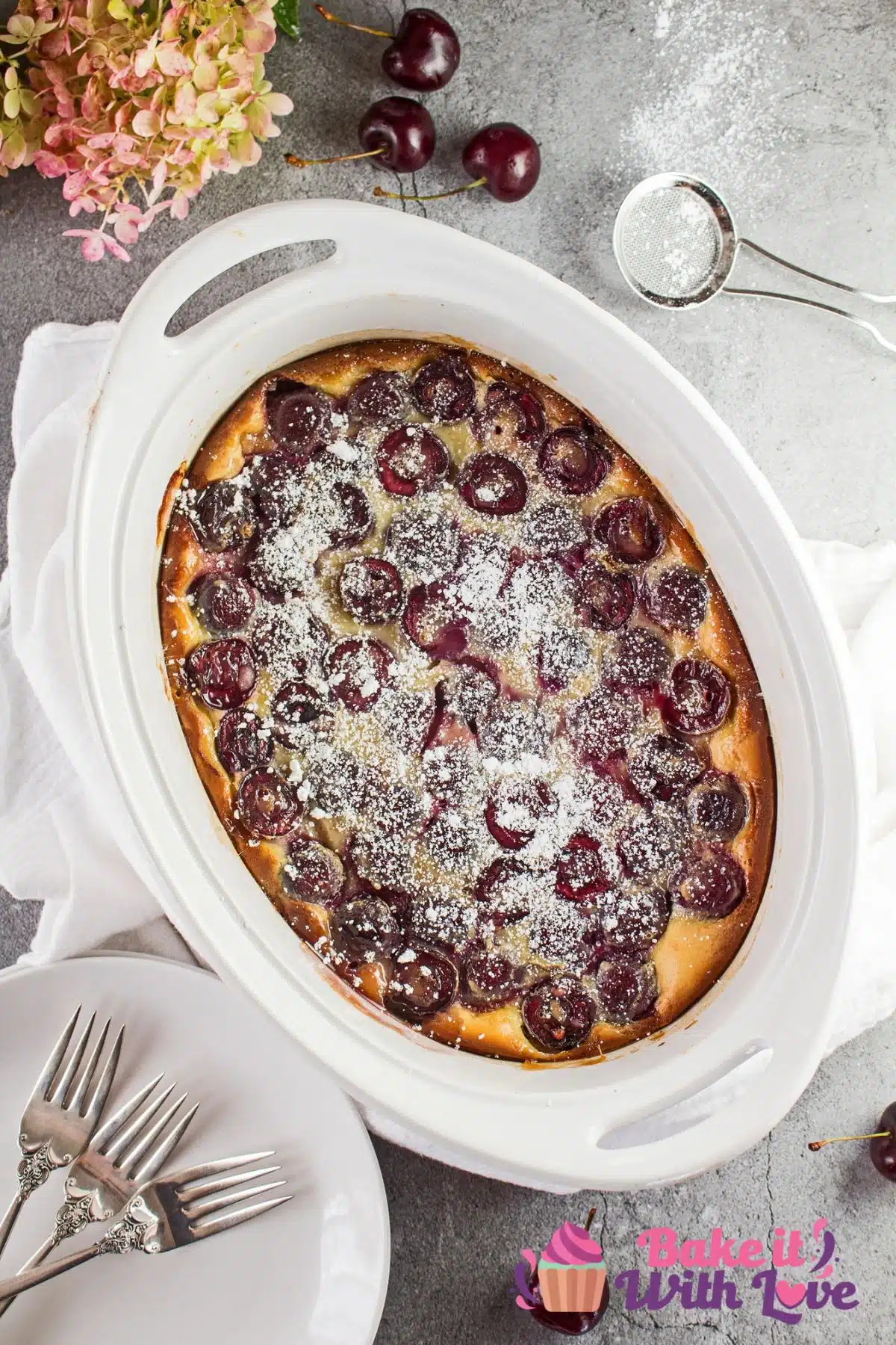Tall image of Bing cherry clafoutis in a white dish.