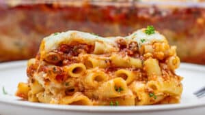 Tender pasta is combined with hearty meat sauce, ricotta, and cheese to make my baked ziti casserole dinner.