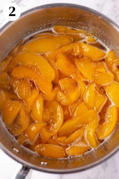 Paula Deen's Southern peach cobbler process photo 2 peaches after cooking down to thicken the syrup.