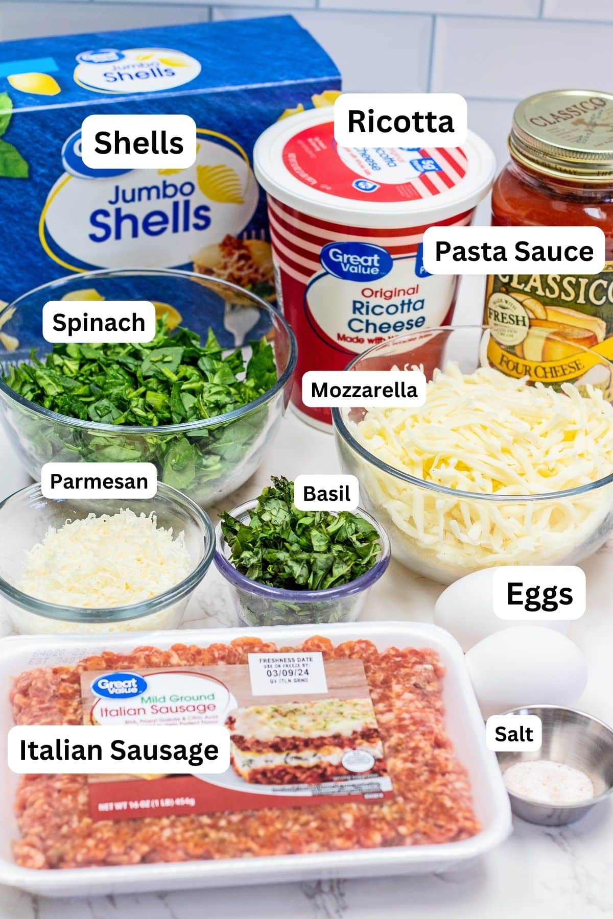 Stuffed shells with spinach and Italian sausage ingredients measured out with labels.