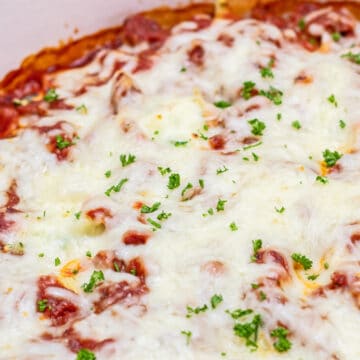 Easy, classic stuffed shells recipe with spinach and sausage baked in a shallow Dutch oven.