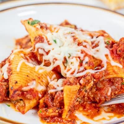 Classic stuffed shells recipe with spinach and Italian sausage then topped with more cheese.