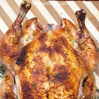 Pin image of roast Capon chicken on a cutting board.