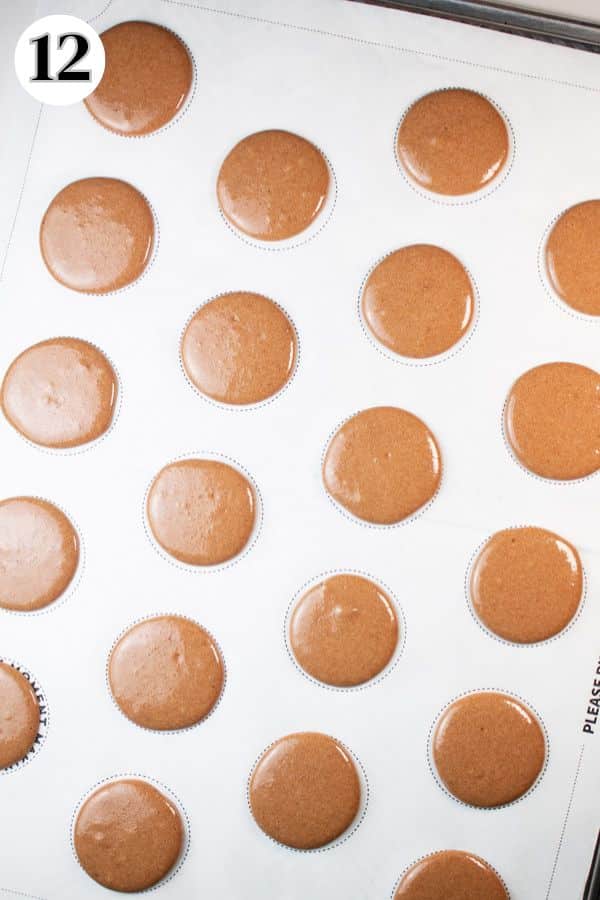 Chocolate macarons process photo 12 macaron shells piped onto the baking sheet with macaron template.