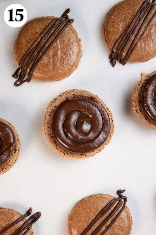 Chocolate macarons process photo 15 ganache filling piped into the cookies.