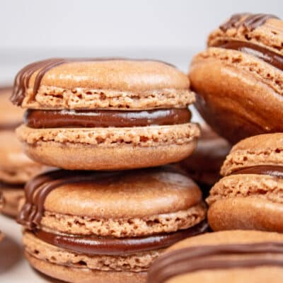 Delicious chocolate macarons filled with chocolate ganache and drizzled with chocolate.