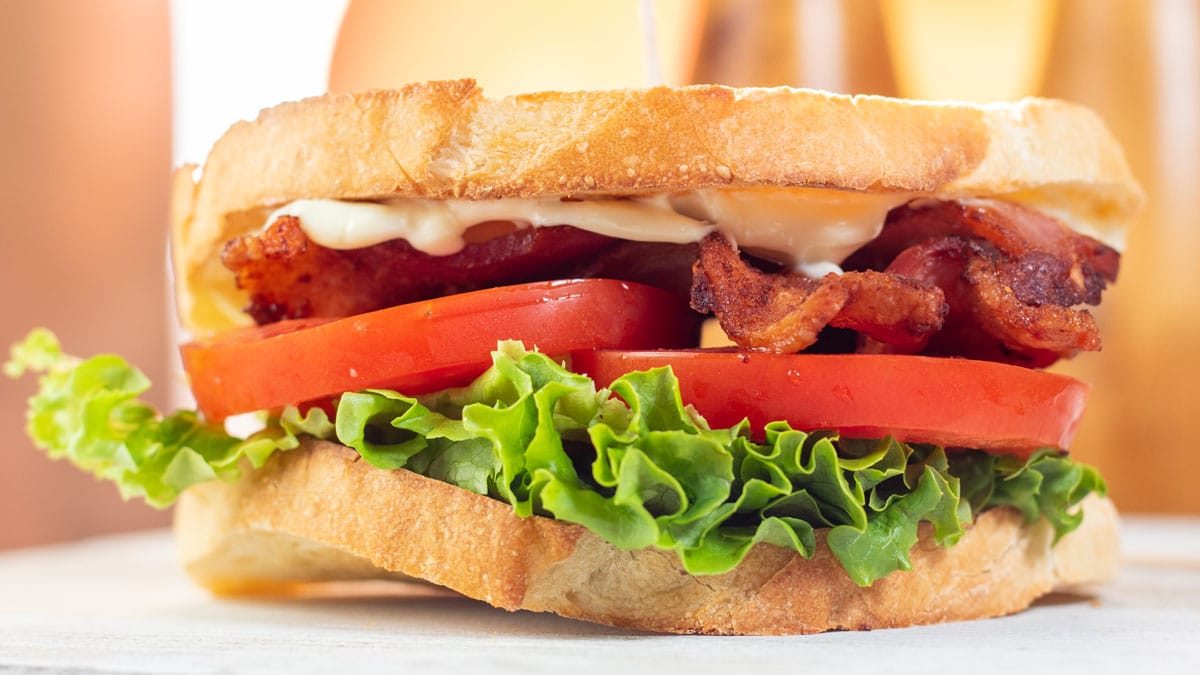 Wide image of a homemade classic BLT sandwich.