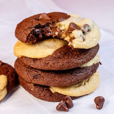 Tasty brookies stacked with the top cookie having a bite taken out of it.