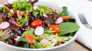 Wide side image of a green garden salad.