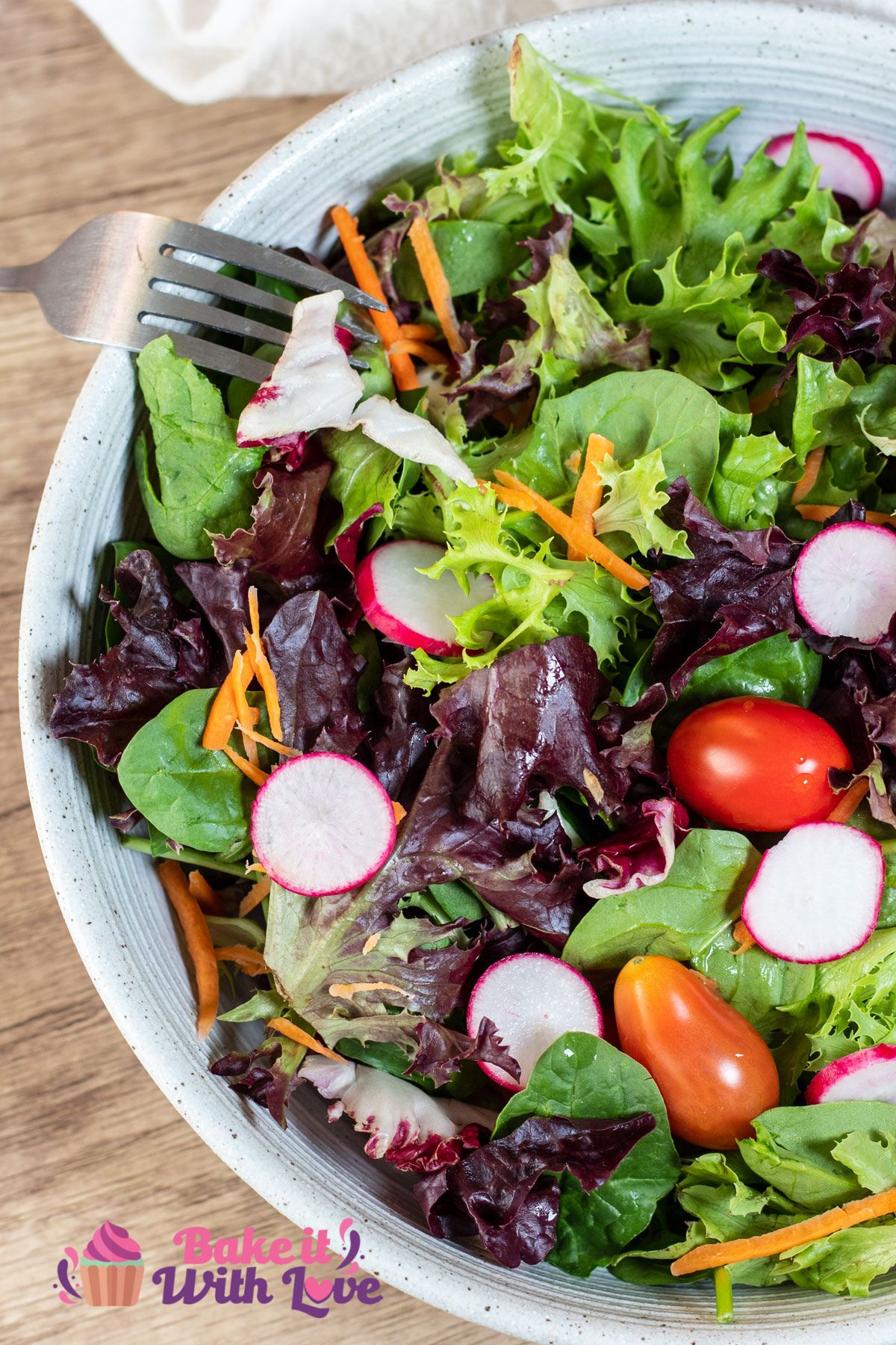 Tall overhead image of a green garden salad.