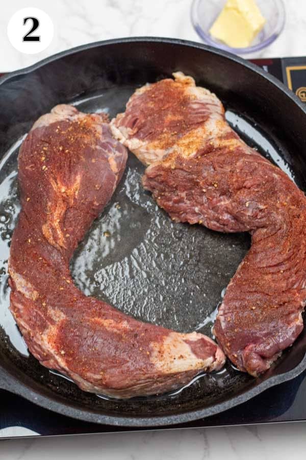 Process image 2 showing hanger steaks in cast iron pan.