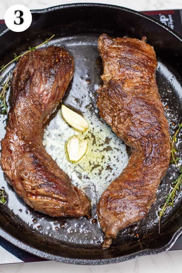 Process image 3 showing hanger steaks flipped over in cast iron pan with added butter.