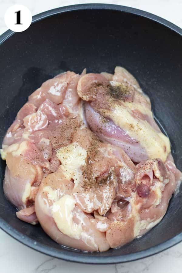 Process image 1 showing chicken seasoned in bowl.