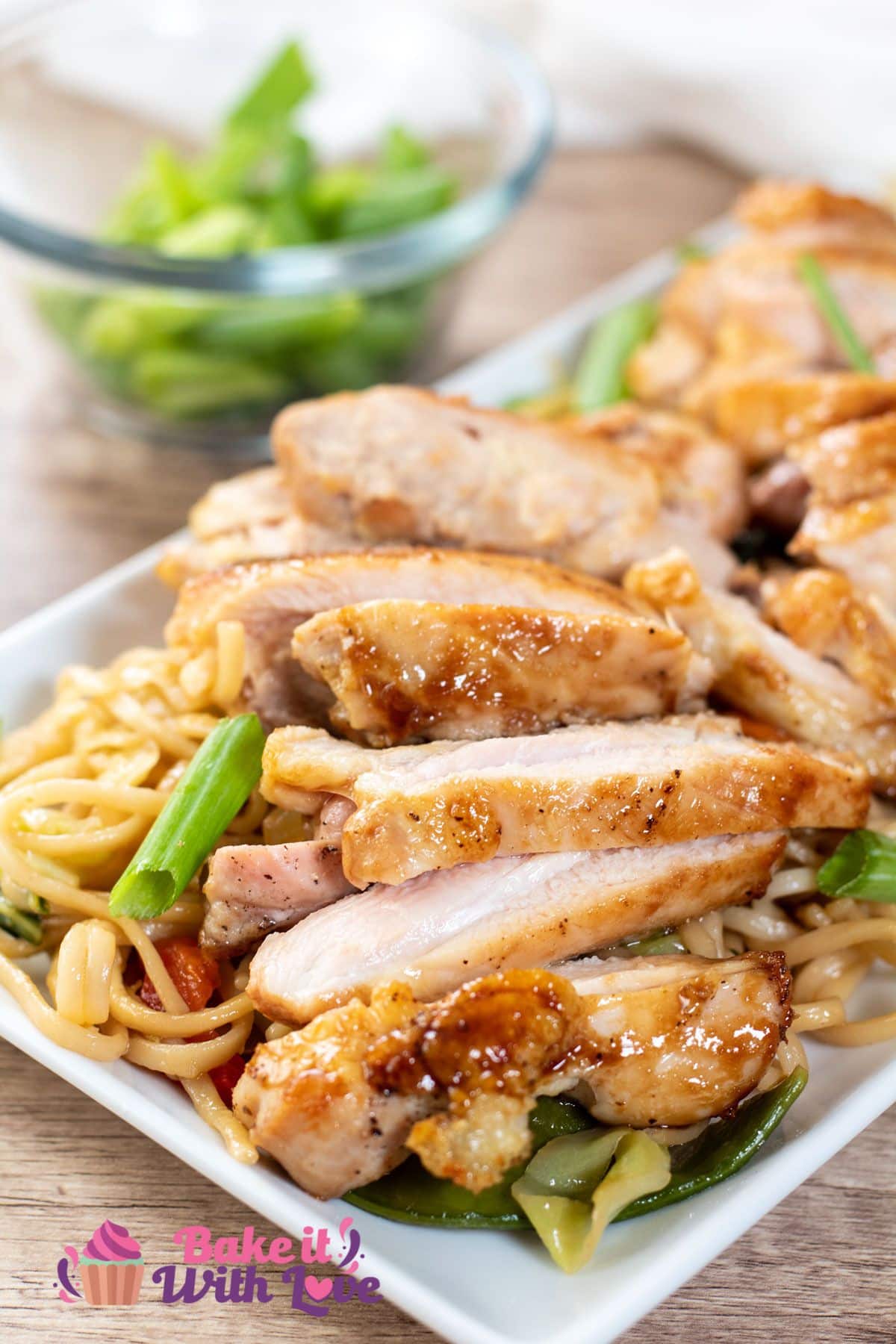 Tall image of Panda express teriyaki chicken on a white plate with lo mein.