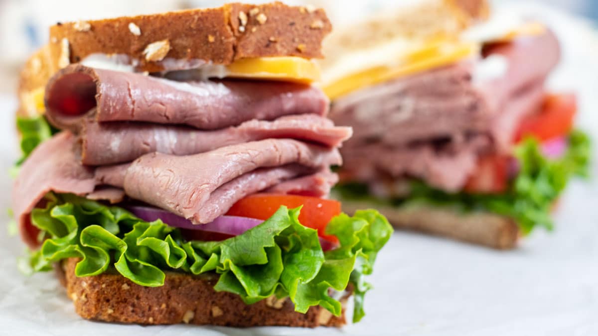 Wide image of a classic roast beef sandwich.
