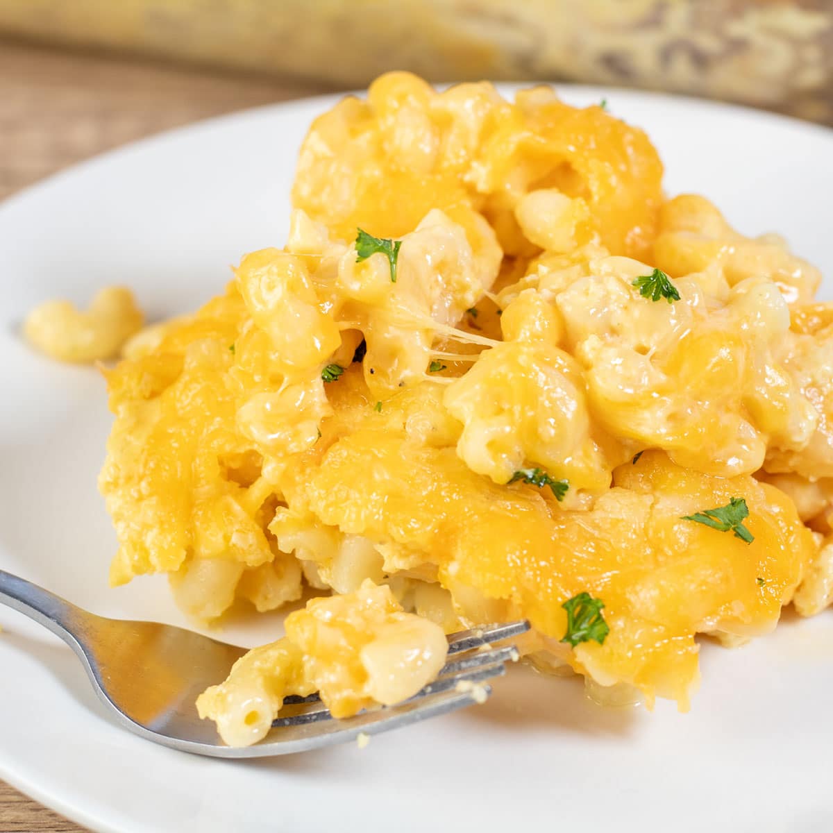 Square image of Cracker Barrel mac and cheese on a white plate.