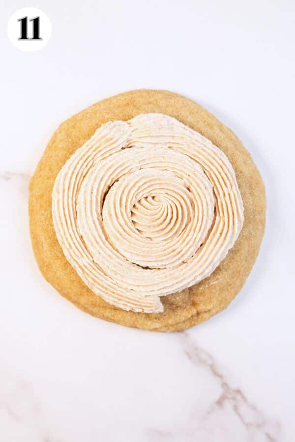 CRUMBL churro cookies process photo 11 cinnamon buttercream frosting piped onto cooled cookie.