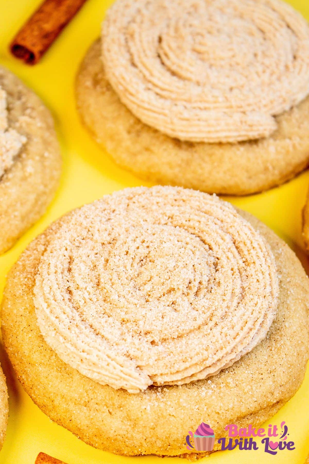 Delicious cinnamon-sugar coated CRUMBL churro cookies topped with cinnamon buttercream frosting piped in a spiral.